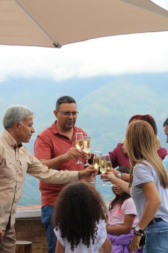 a group of people holding glasses of wine at Granja, Cafetalera Alegría 1 in Mérida