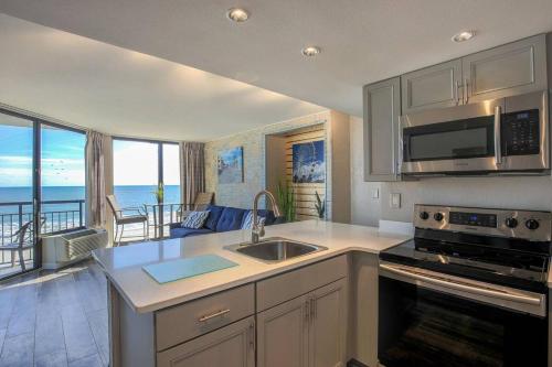 a kitchen with a view of the ocean at Unique Oceanfront Luxury Suite, Dogs Welcome! 406 in Myrtle Beach