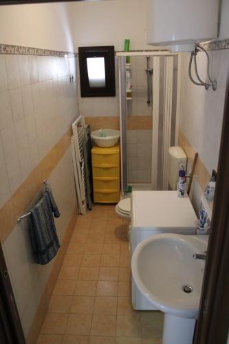 a small bathroom with a sink and a toilet at Casa di Agata in Torrenova