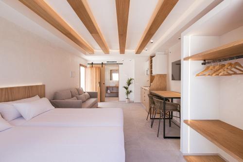 a bedroom with a bed and a living room at Malacosta Sky Suites - MC Apartments Ibiza in Ibiza Town