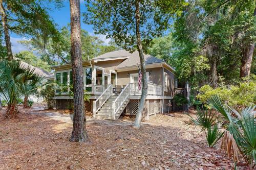 a house with a porch and stairs in the woods at 3074 Baywood in Seabrook Island