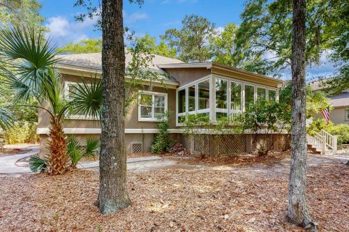 a house with a conservatory with trees in front of it at 3074 Baywood in Seabrook Island