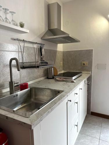 a kitchen with a stainless steel sink and a stove at Le Terrazze - Holiday Home near the Beach in Monterosso al Mare