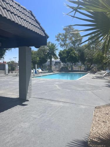 a swimming pool in a parking lot at Ocotillo Apartments & Hotel in Phoenix