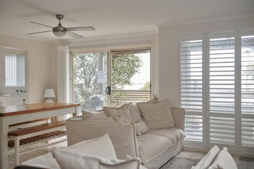 a living room with a couch and a piano at Castaway 2 in Harrington