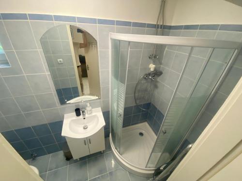 a bathroom with a shower and a sink and a mirror at Kuckó Zóna Balatonfenyves in Balatonfenyves