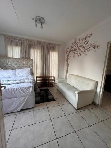 a bedroom with a bed and a dog laying on the floor at Tanya's home in Johannesburg