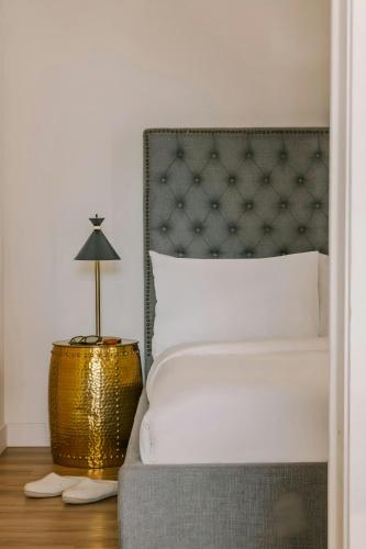 a bedroom with a bed and a lamp on a table at Sonder by Marriott Bonvoy Maisonneuve Apartments Downtown in Montréal