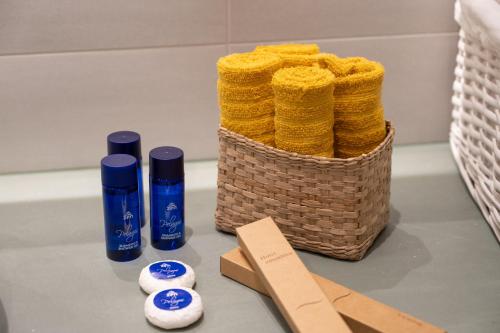 a basket of towels next to two bottles of soap at Urban Loft Chalkida in Chalkida