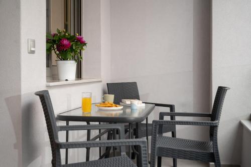 a small table and chairs with a plate of food on it at Urban Loft Chalkida in Chalkida