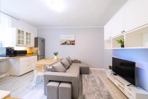 a living room with a couch and a table at Baltic Cliff Apartment- Babie Doły in Gdynia