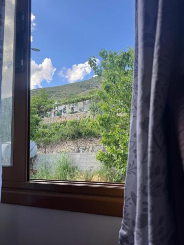 a window with a view of a mountain at Bedena House in Kolonjë