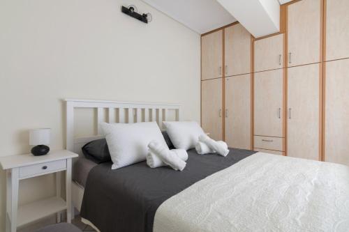 a bedroom with a bed with two white pillows at Apartment with a private rooftop in Piraeus