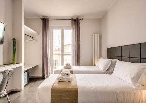 A bed or beds in a room at Floor 6 Boutique Rooms by DOT Suites