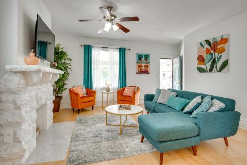 a living room with a blue couch and a fireplace at Luxurious 2BR Kansas City Condo Near Downtown in Kansas City