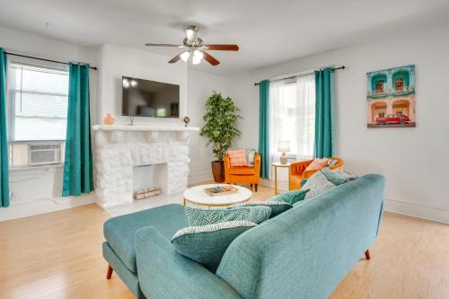 a living room with a blue couch and a fireplace at Luxurious 2BR Kansas City Condo Near Downtown in Kansas City