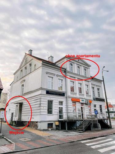 a large white building with a red circle around it at Apartament Pastelowy Kwidzyn in Kwidzyn
