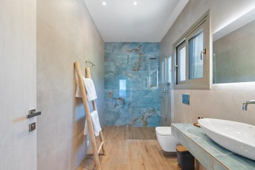 a bathroom with a sink and a toilet at Calliste Villa in Évyiros