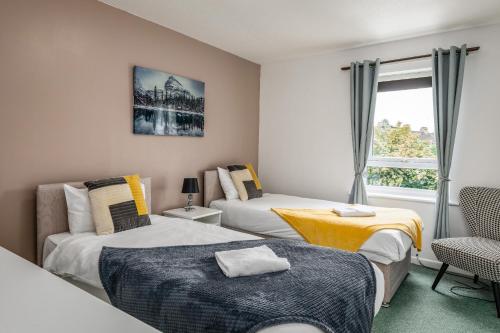 a bedroom with two beds and a window at Summer Deal 20 PRC OFF 4BR 2BATH Families Groups By Trinity Stays Short Lets & Serviced Accommodation Cambridge in Cambridge