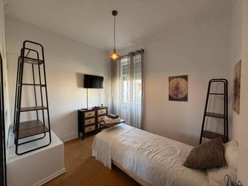 a bedroom with two bunk beds and a desk at Casa das Muralhas in Peniche