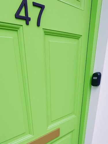 a green door with the number on it at Wolfe Tone Apartment in Sligo