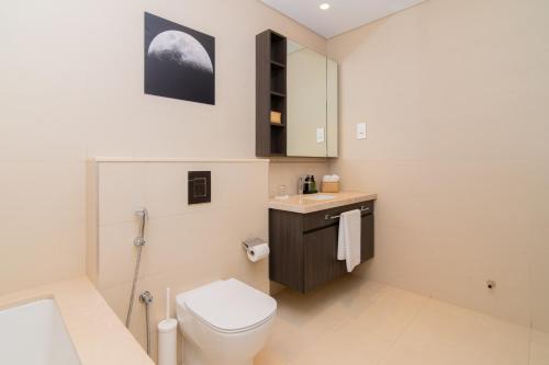 a bathroom with a toilet and a sink at Elite Escape Holiday Home - 1 BHK Getaway with Dubai Mall Access - 3310 in Dubai