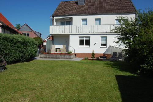 a large white house with a lawn in front of it at Ferienwohnung Stollenwerk am Steinhuder Meer An der Schanze 13 in Steinhude