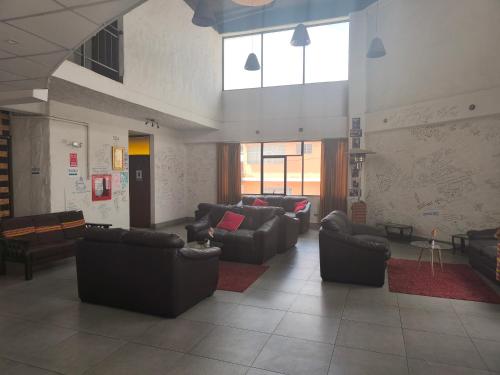a living room with couches and chairs in a building at Waalay Hotel in Huancayo