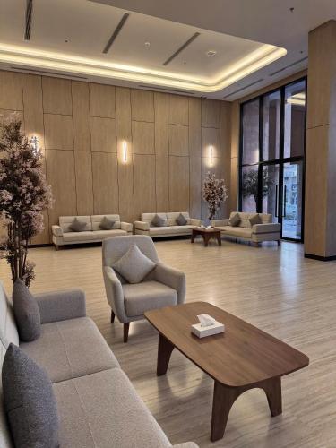 a living room with couches and a coffee table at Regency View Hotel in Al Madinah