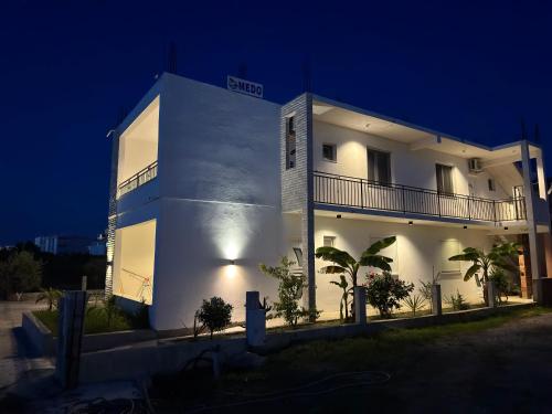 a white building at night with aventh floor at Medo in Ulcinj