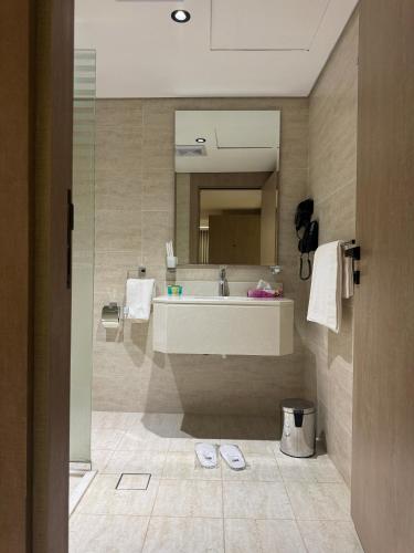 a bathroom with a sink and a mirror at Regency View Hotel in Al Madinah
