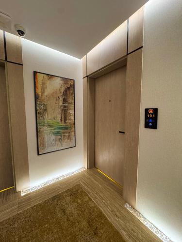 a hallway with a door and a painting on the wall at Regency View Hotel in Al Madinah