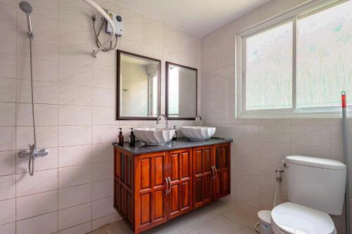 a bathroom with two sinks and a toilet at Kamala Heights Villa in Kamala Beach