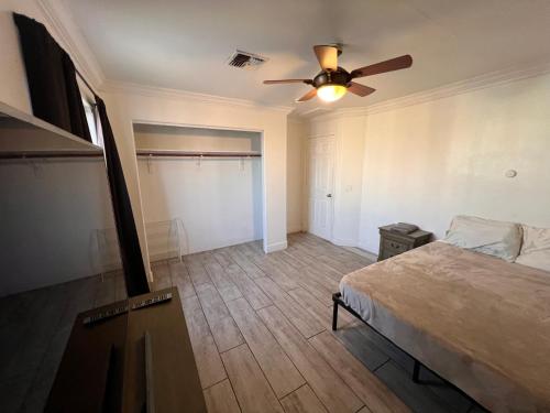 a bedroom with a bed and a ceiling fan at Downtown Secluded Room 3 in Phoenix