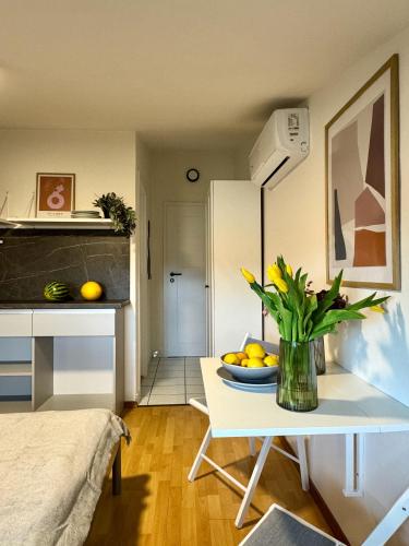 a room with a table with a bowl of fruit on it at Apartments & Zimmer Jasmine in Funtana