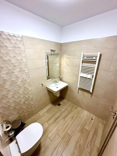 a bathroom with a sink and a toilet and a mirror at Summerland Seaview Apartments in Mamaia