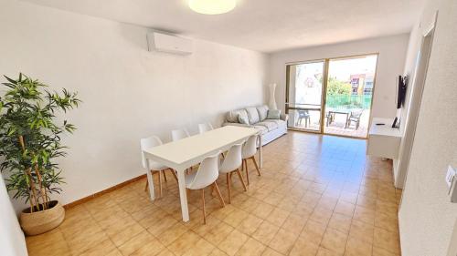 a white dining room with a white table and chairs at Céntrico La Cova para 8 Pax con Plaza de Garaje in Peñíscola