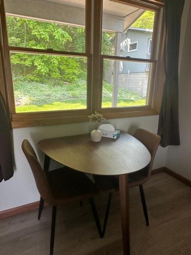 a table and chairs in a room with a window at DownTown Inn in Sister Bay