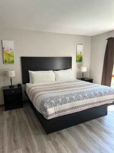 a bedroom with a large bed with two night stands at DownTown Inn in Sister Bay