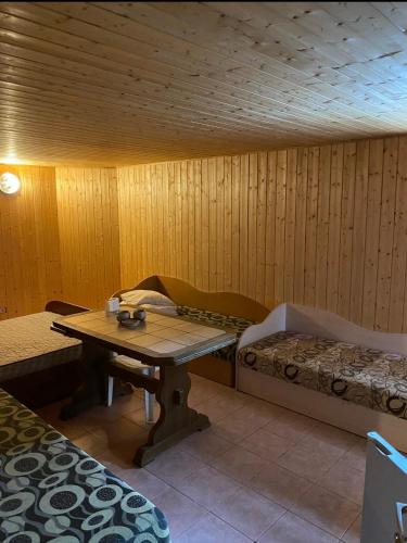 a room with a table and a bed in a room at V36 Žemutinė studija in Palanga