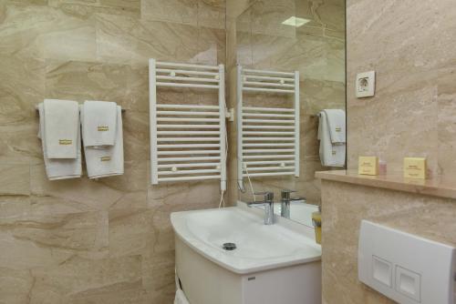 a bathroom with a sink and a mirror at Apartments Menuet in Budva