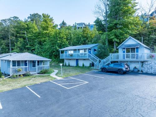 a house with a car parked in a parking lot at DownTown Inn in Sister Bay