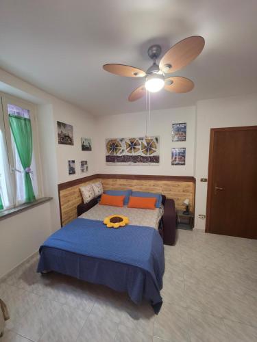 a bedroom with a bed and a ceiling fan at Affittacamere Girasole in Foligno