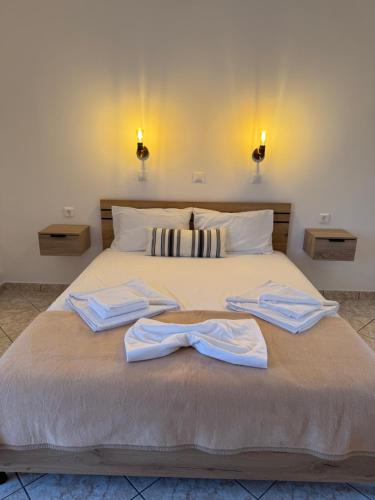 a bedroom with a bed with two towels on it at Aktea Apartments II in Kefalos