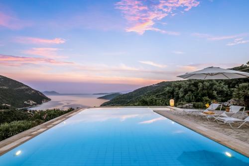 a swimming pool with a view of the ocean at Kronos Estate Lefkada - 5 star luxury in Mikros Gialos