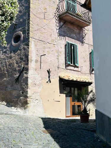 a brick building with a window and a balcony at Suite Dreams in Anguillara Sabazia
