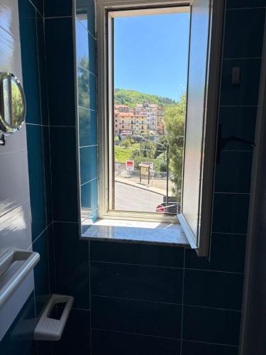 a bathroom with a window with a view of a street at La Meridiana Bed & Bike in Celico