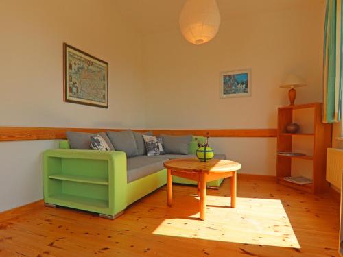 a living room with a couch and a table at Ferienhaus am Garder See Inselblick in Lohmen