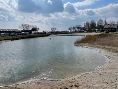 a body of water on the side of a beach at Coastal Comfort on Poel Island in Insel Poel