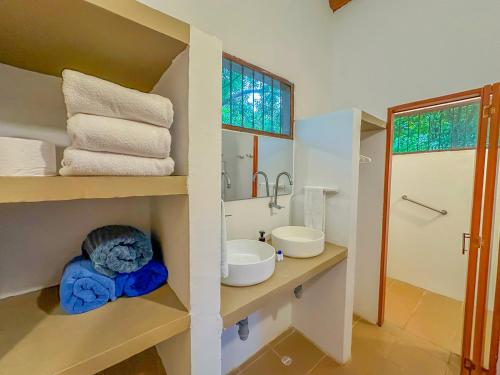 a bathroom with two sinks and a mirror at Hotel Chiniu in Palomino
